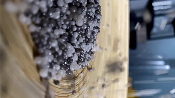 Pouring Small Decorative Beads Onto Large Ceramic Plate