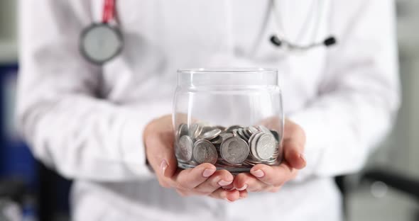 Doctor in White Coat Holding Jar of Coins in His Hands Closeup  Movie