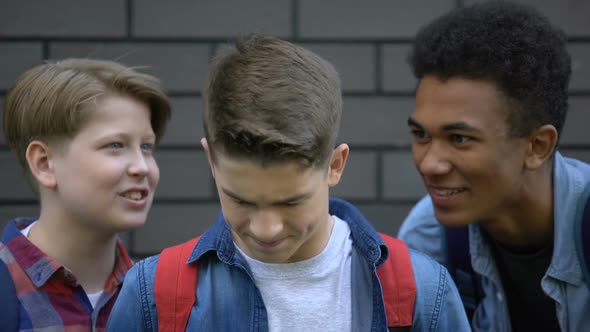 Depressed Boy Covering Ears From Mockery and Insults of Schoolmates, Bullying