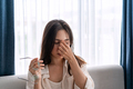 Young woman rubbing her eyes feel painful and take off her glasses - PhotoDune Item for Sale