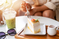 Young woman enjoying eating dessert and drinks in cafe while traveling - PhotoDune Item for Sale