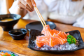 Young asian woman eating sashimi set in japanese restaurant - PhotoDune Item for Sale