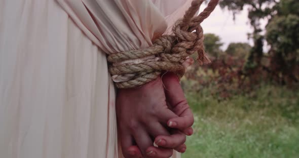 Closeup of a woman with her hands tied