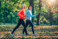 Female Friends Jogging in Public Park. Autumn, Fall. - PhotoDune Item for Sale