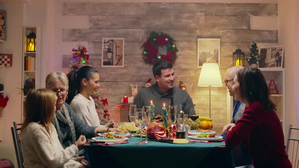 Adult Man Taking a Photo with the Family at Christmas Reunion