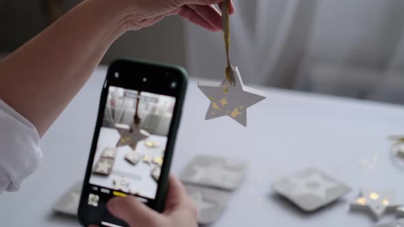 Woman Photographs a Finished Handicraft for Her Social Networks