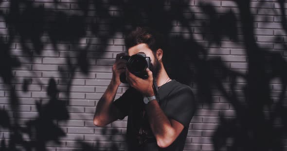 Photographer focuses and snaps image of subject