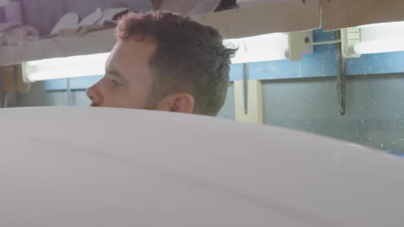 Male surfboard maker in his workshop