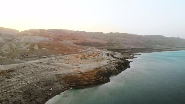 Dead sea drone view 4k flight over the salt lake looking at the road
