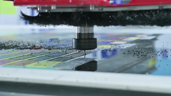 milling automated machine cuts shapes from a plastic blank