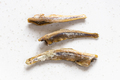 few dried anchovy fishes close up on gray - PhotoDune Item for Sale