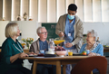 Group of cheerful seniors enjoying breakfast in nursing home care center - PhotoDune Item for Sale