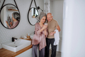 Senior couple in love in bathroom, using smartphone, morning routine concept - PhotoDune Item for Sale