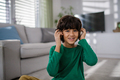 Happy multiracial boy with headphones listening to music at home - PhotoDune Item for Sale