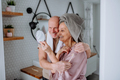 Senior couple in love in bathroom, looking at mirror and smiling, morning routine concept - PhotoDune Item for Sale