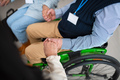 Close-up of senior man sitting in wheelchair at group therapy session - PhotoDune Item for Sale