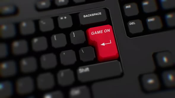 Game On red button on keyboard. A finger presses Enter. Click Game On. Realistic close-up button