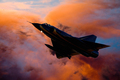 Composite image of fighter jet aircraft silhouette against orange clouds - PhotoDune Item for Sale