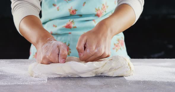 Woman kneading a dough 4k