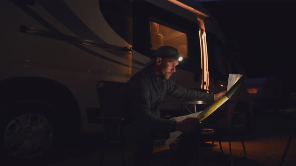 Reading Local Trials Map in Front of His Camper Van
