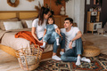 A happy young family spends time together in a home interior. Family relationship concept - PhotoDune Item for Sale