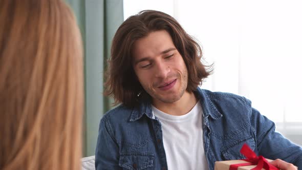 Loving Husband Giving Gift To His Beloved Wife and Smiling Close Up Portrait of Man Slow Motion