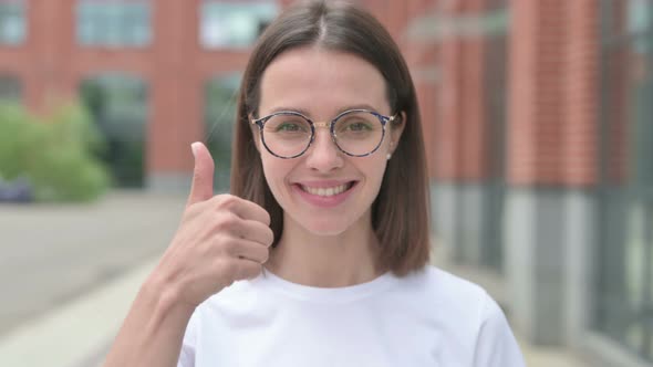 Thumbs Up by Young Woman, Outdoor