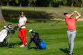 Smiling golfing couple enjoying a game of golf - PhotoDune Item for Sale