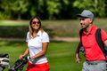 Golfing couple enjoying a game on a golf course - PhotoDune Item for Sale