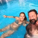 Happy caucasian people couple have fun and enjoy the swimming activity at the pool - VideoHive Item for Sale