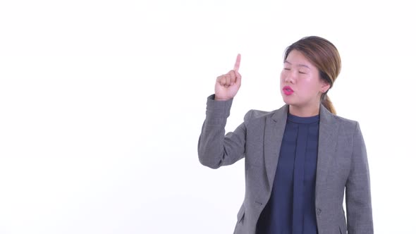 Stressed Young Asian Businesswoman Talking While Pointing Up
