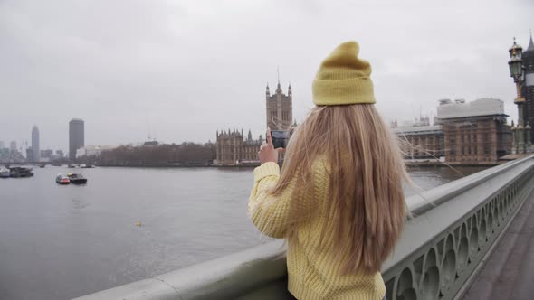 Teenage Tourist Filming With Smartphone Over City