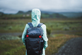 Woman with backpack and green jacket on travel in Iceland - PhotoDune Item for Sale
