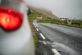 Car stoped on the road with view of typical rural Icelandic Church with red roof in Vik region - PhotoDune Item for Sale