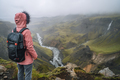 Woman wearing lilac jacket with backpack enjoying icelandic highland and river fossa close to - PhotoDune Item for Sale