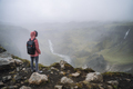 Close up of a woman with backpack enjoying icelandic highland and river fossa close to Haifoss - PhotoDune Item for Sale
