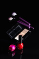Set of cosmetic makeup products. Eyeshadow, nail polish and makeup brushes on black table. - PhotoDune Item for Sale