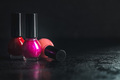 Colorful nail polish bottles on black table. - PhotoDune Item for Sale