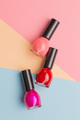 Colorful nail polish bottles on colorful background. - PhotoDune Item for Sale