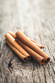 Dry cinnamon sticks on wooden table. Cinnamon spice. - PhotoDune Item for Sale