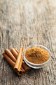 Dry cinnamon sticks and cinnamon powder on wooden table. Cinnamon spice. - PhotoDune Item for Sale