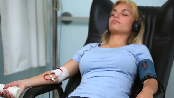 Woman receiving a blood donation while sitting