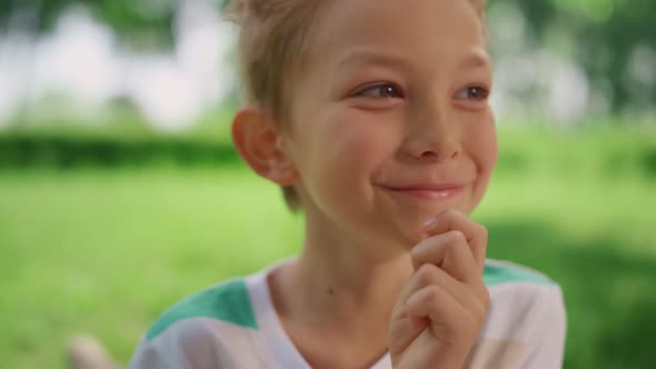 Portrait of Funny Eating Boy on Summer Picnic