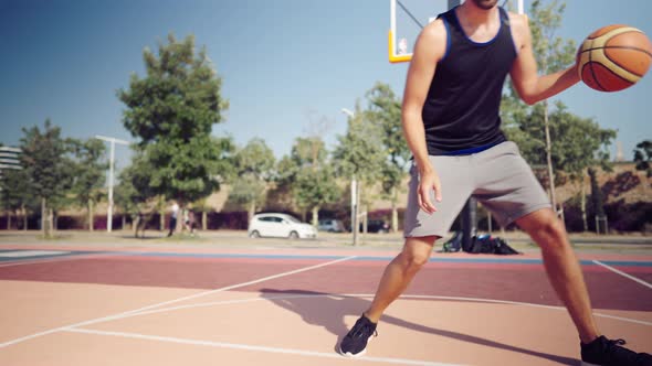 Professional Basketball Player Dribbling the Ball on the Basketball Field