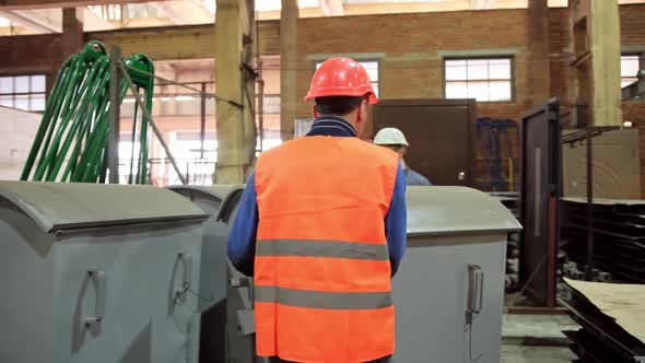 Workers in hard hats inside the plant