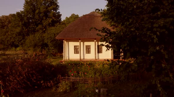 Facade of Traditional Clay House with Garden of Flowers