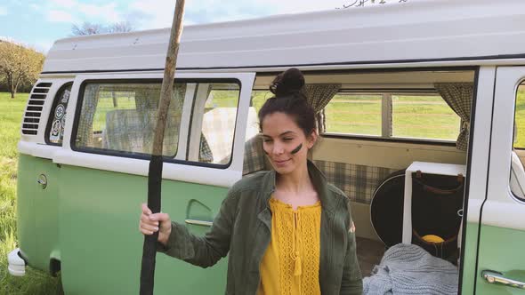 Slow motion shot of young woman with face painting and stick