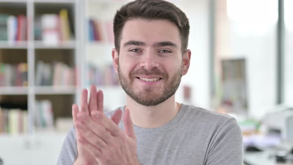 Portrait of Young Man Clapping for Team, Applauding