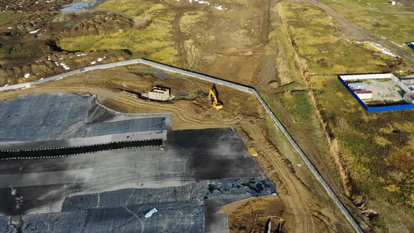 Excavator Works Near Area with Tar and Foil Aerial View