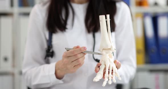 Doctor Shows Anatomy of Skeleton of Leg and Fingers